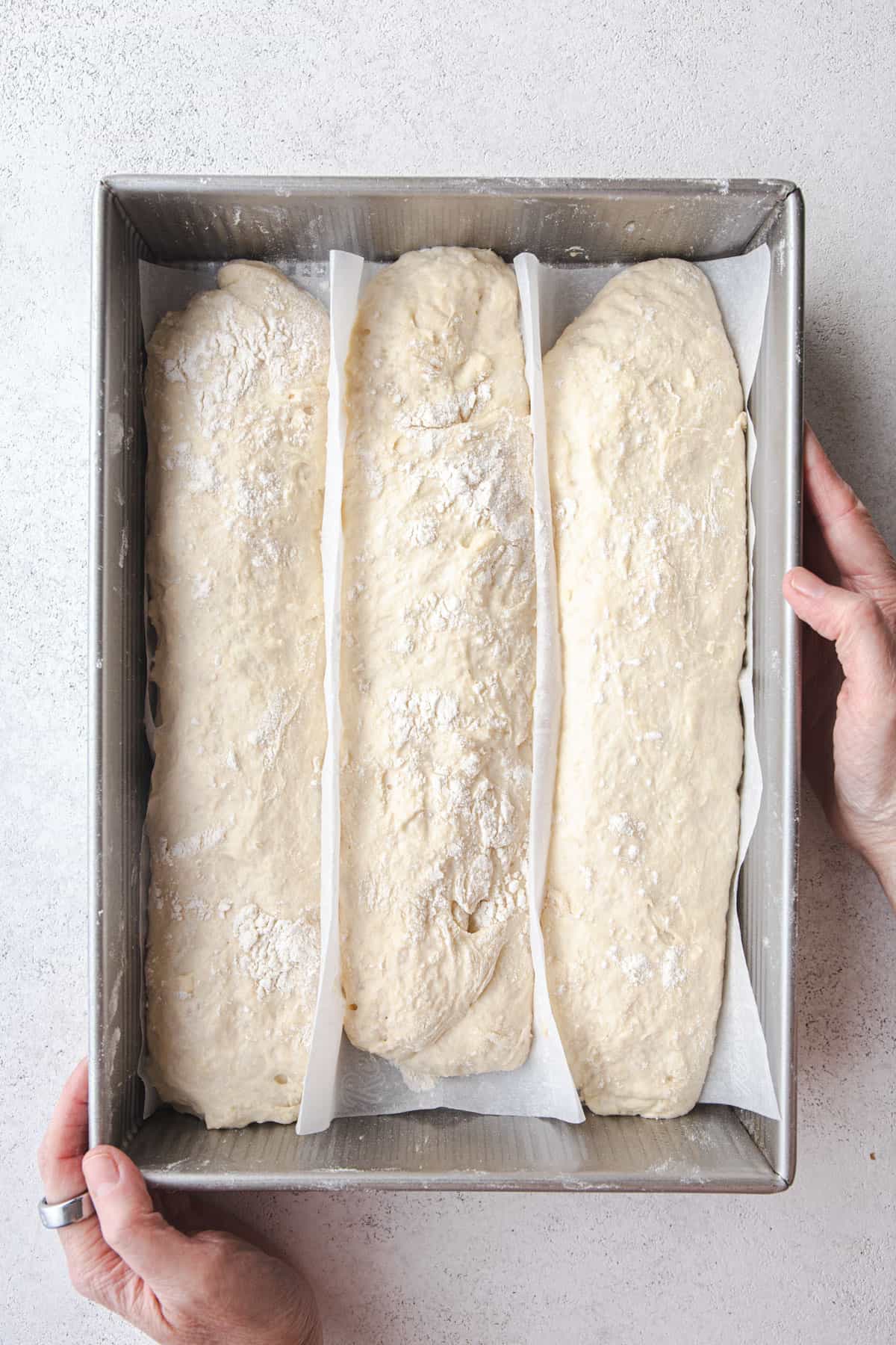 formed bread dough in a metal baking pan