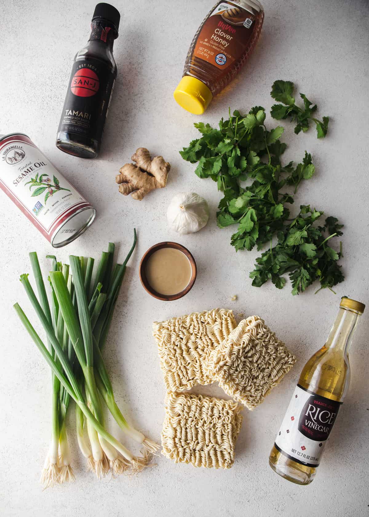 ingredients for miso scallion noodles on a grey countertop