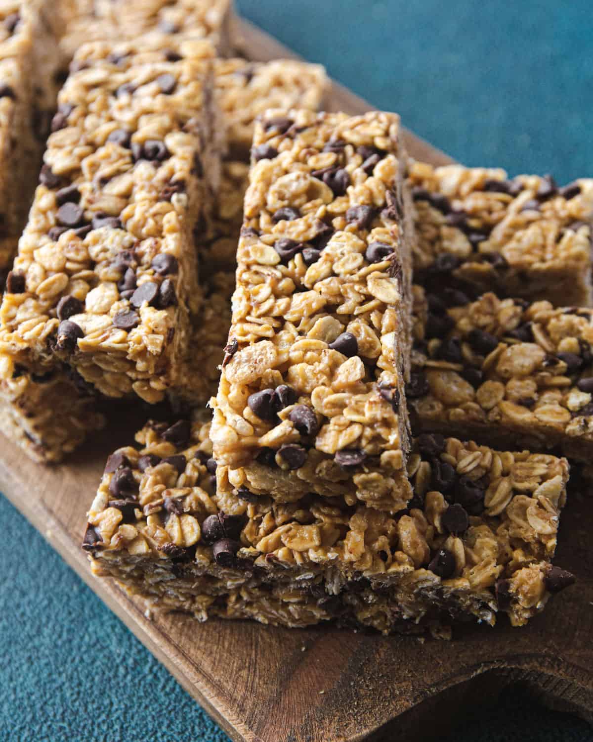 no bake granola bars stacked on a wooden tray