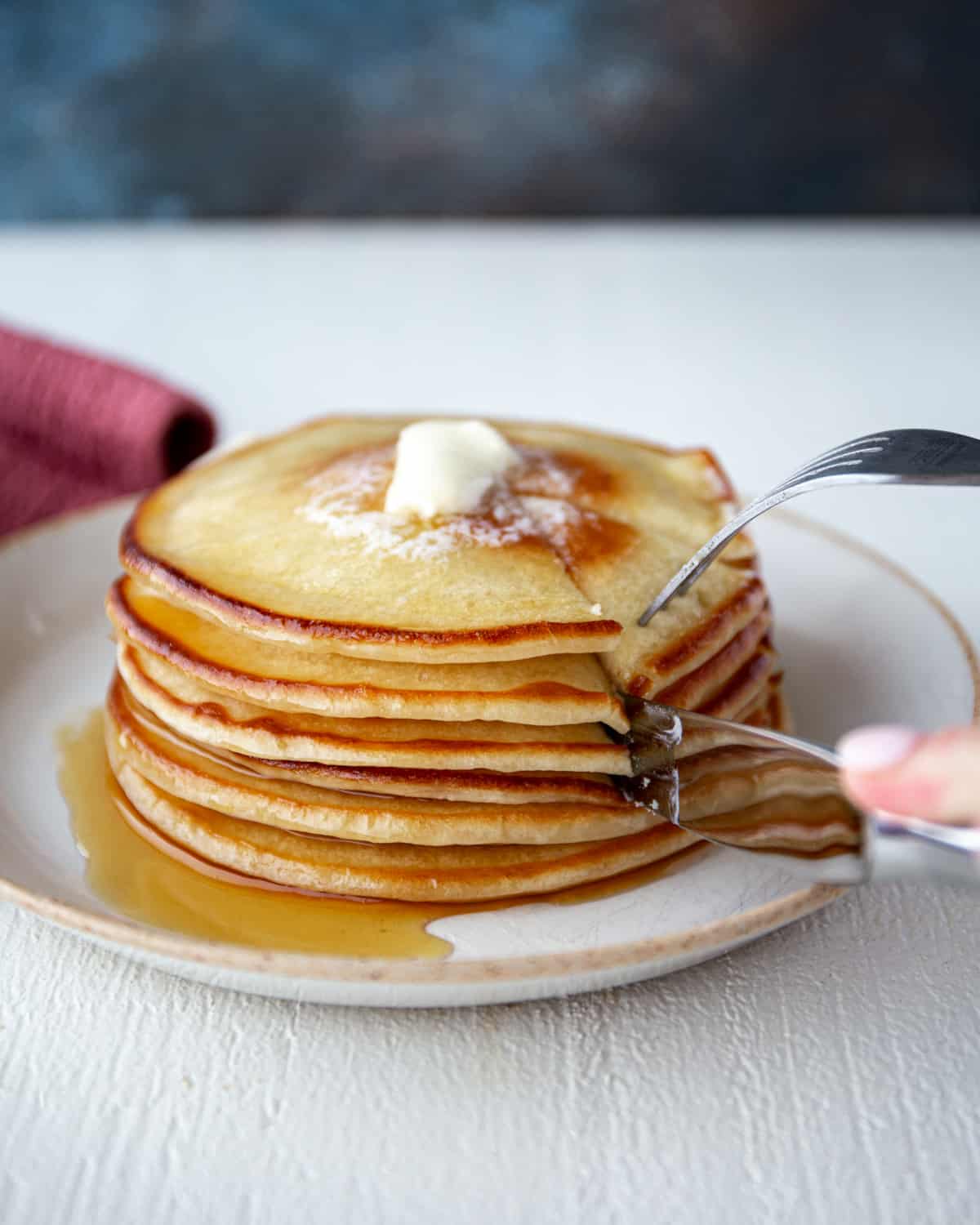 removing a bite of pancakes with a fork