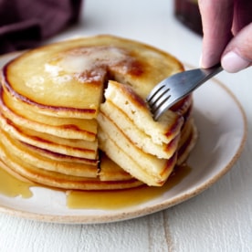 removing a bite from a stack of pancakes