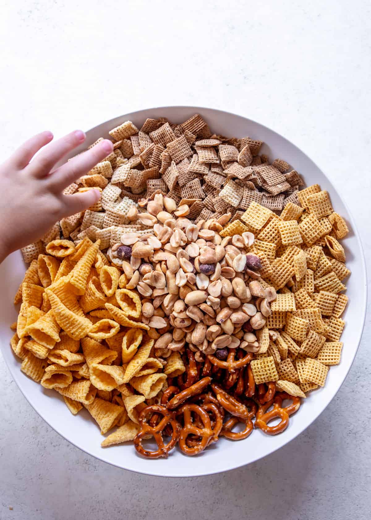 snacks for chex mix in a white bowl