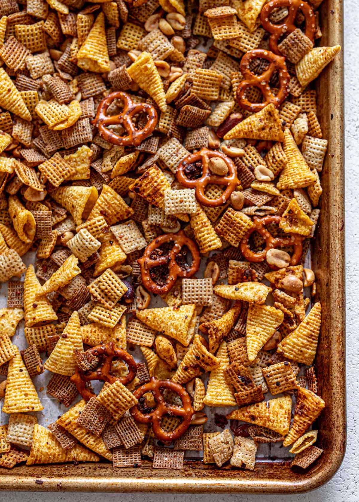 spicy chex mix on a sheet pan