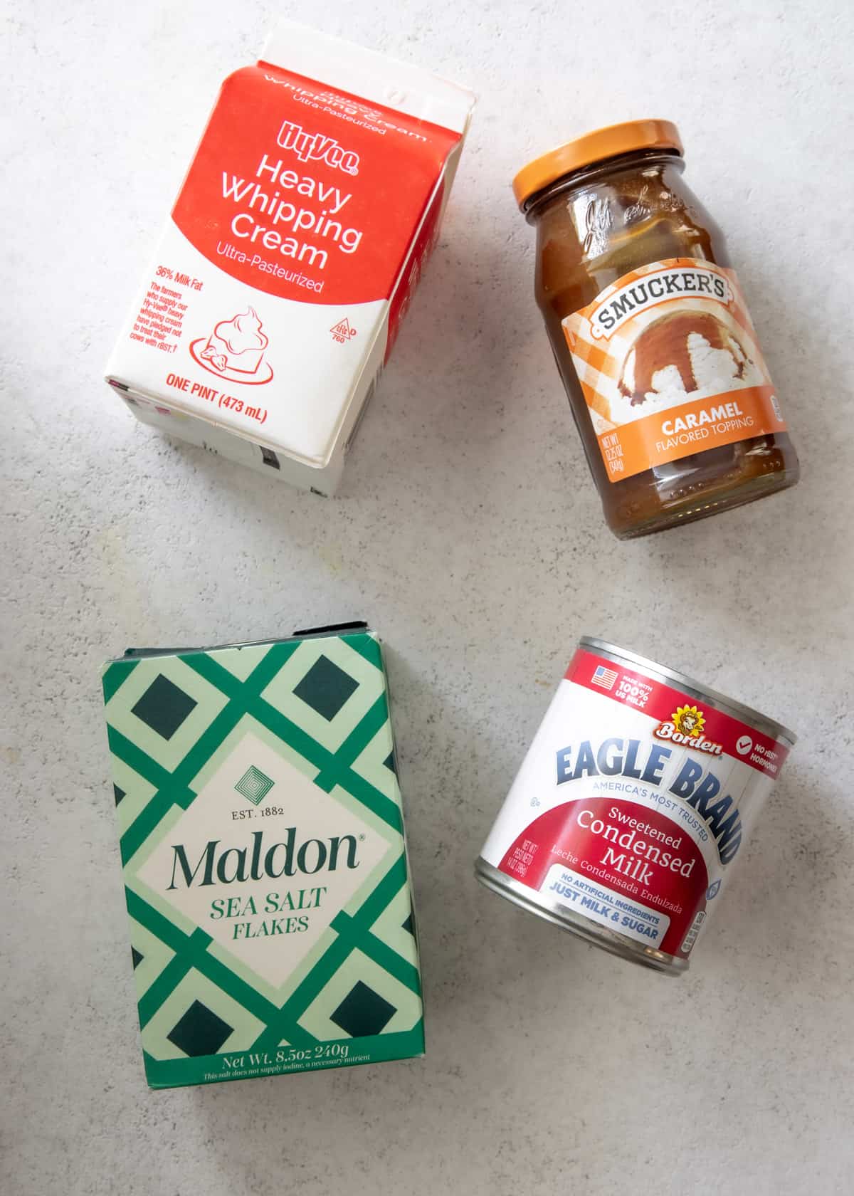 ingredients for sea salt caramel ice cream on a grey countertop