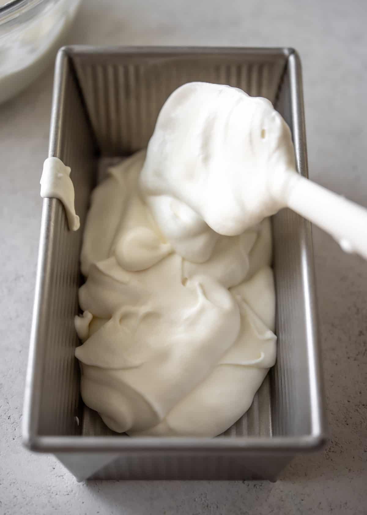 adding ice cream to a metal pan