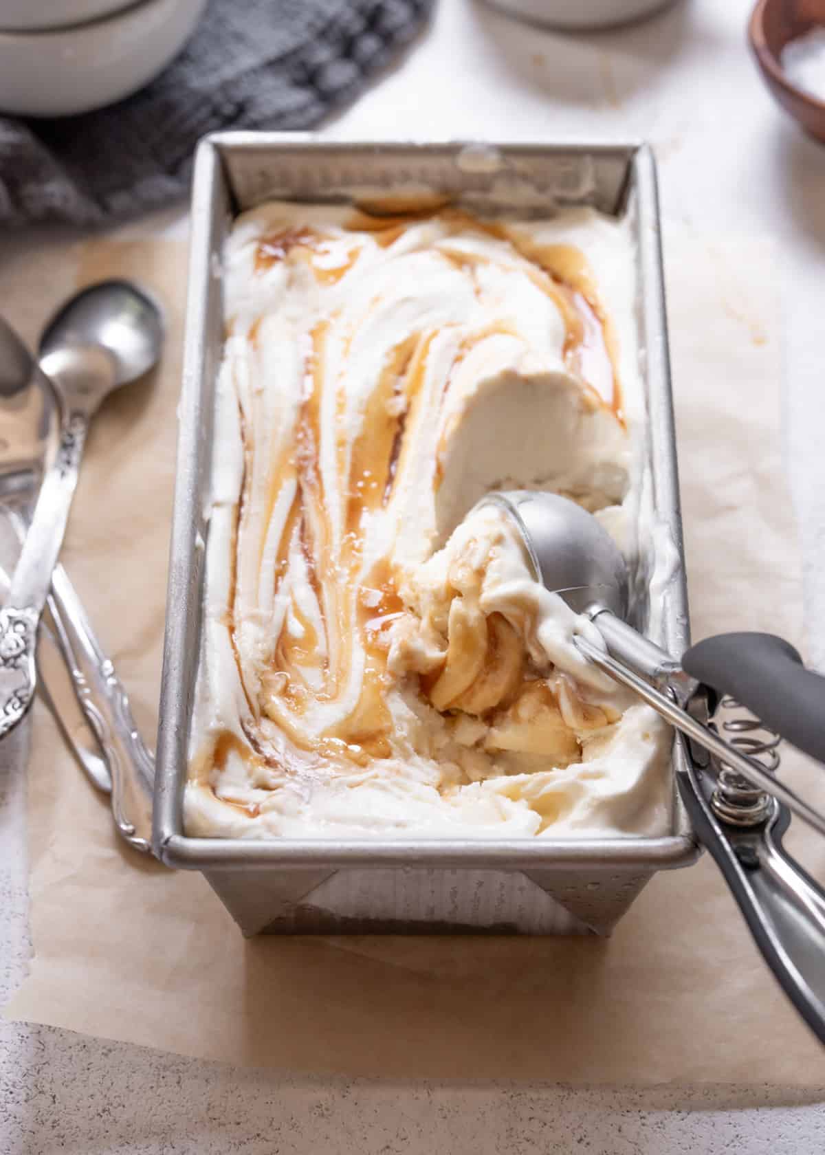 scooping no churn ice cream out of a loaf pan