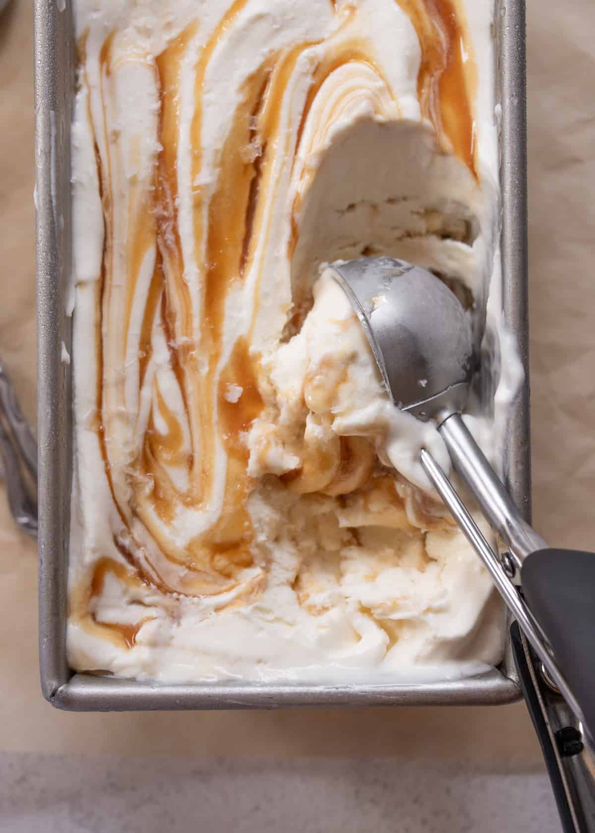 scooping ice cream out of a pan
