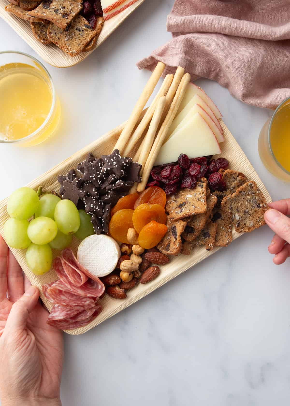charcuterie on a small bamboo tray