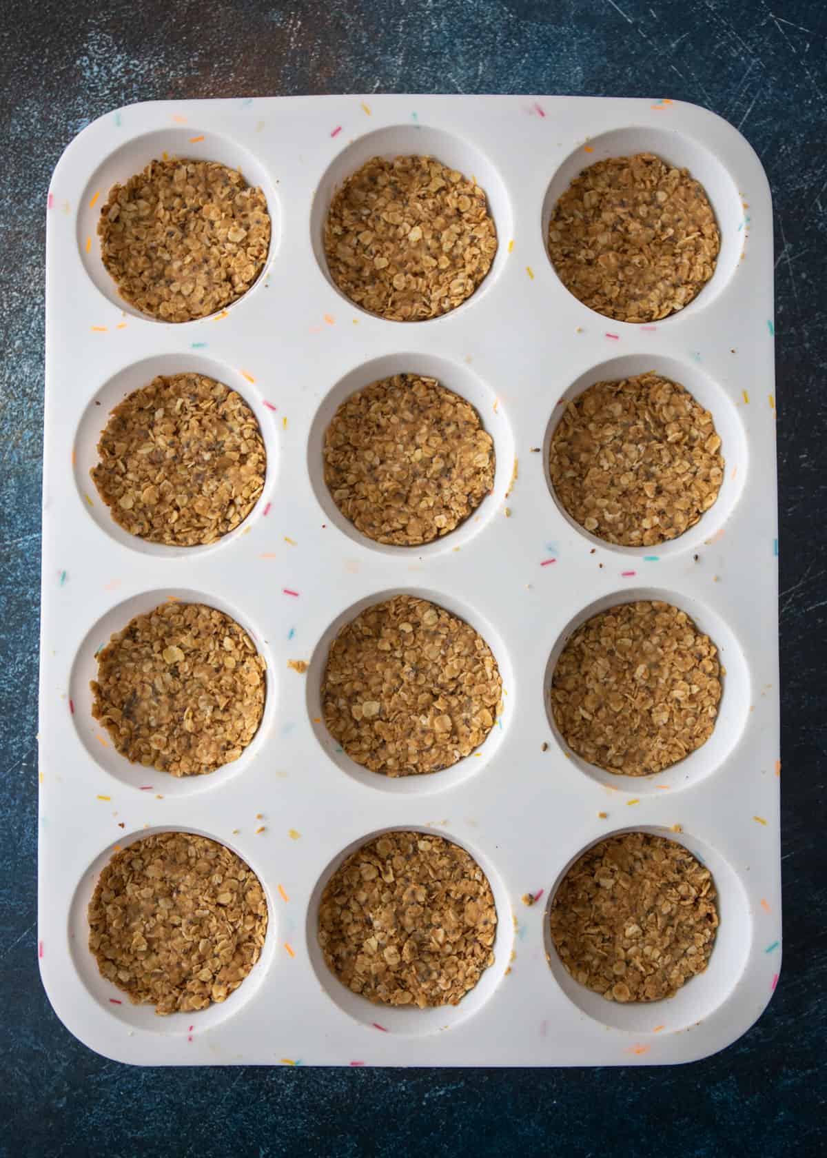 oat mixture pressed into the bottom of a muffin tin