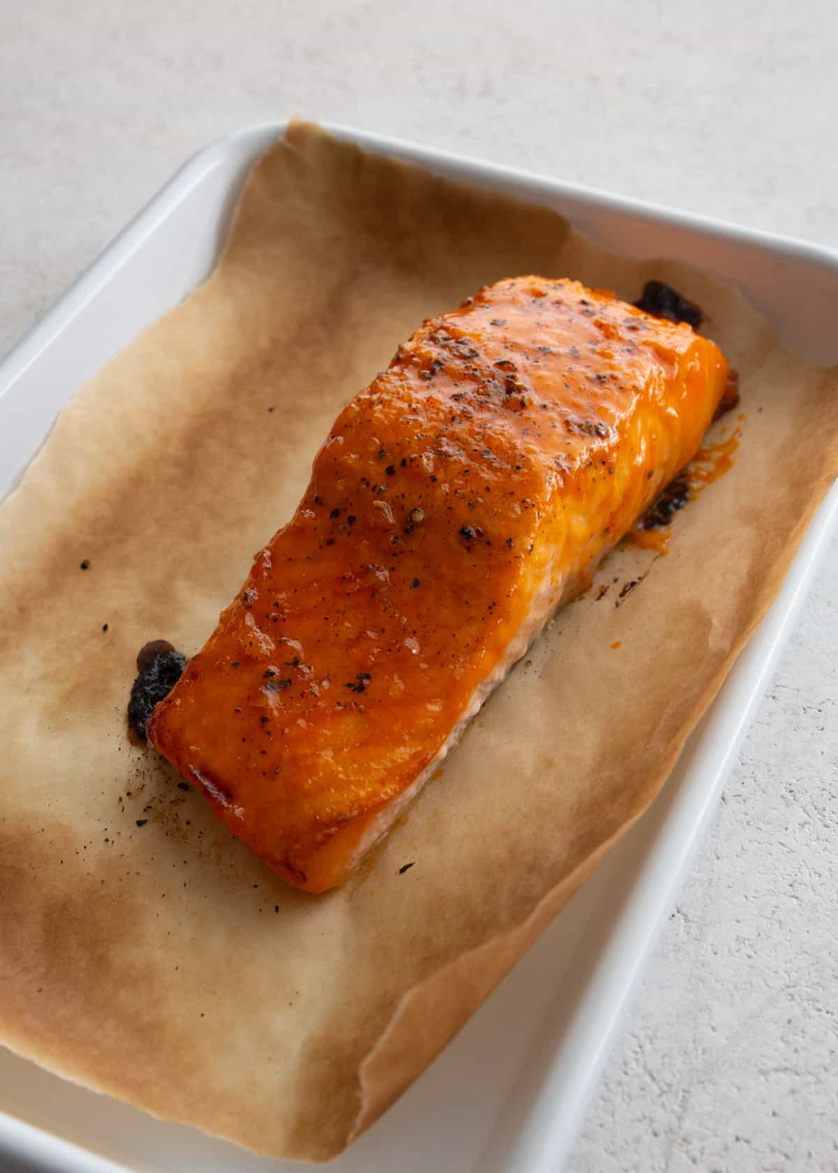 a salmon filet on a parchment lined sheet pan