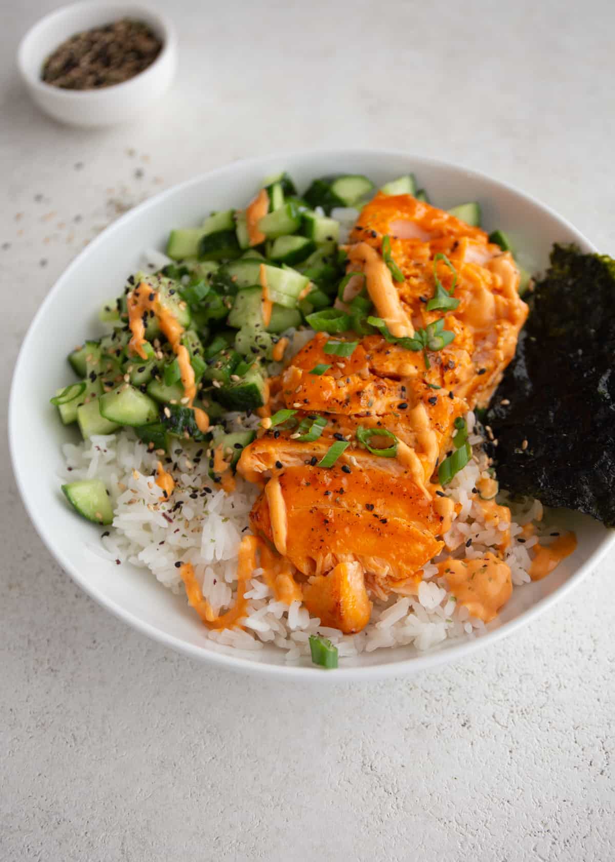 salmon, vegetables and rice in a white bowl