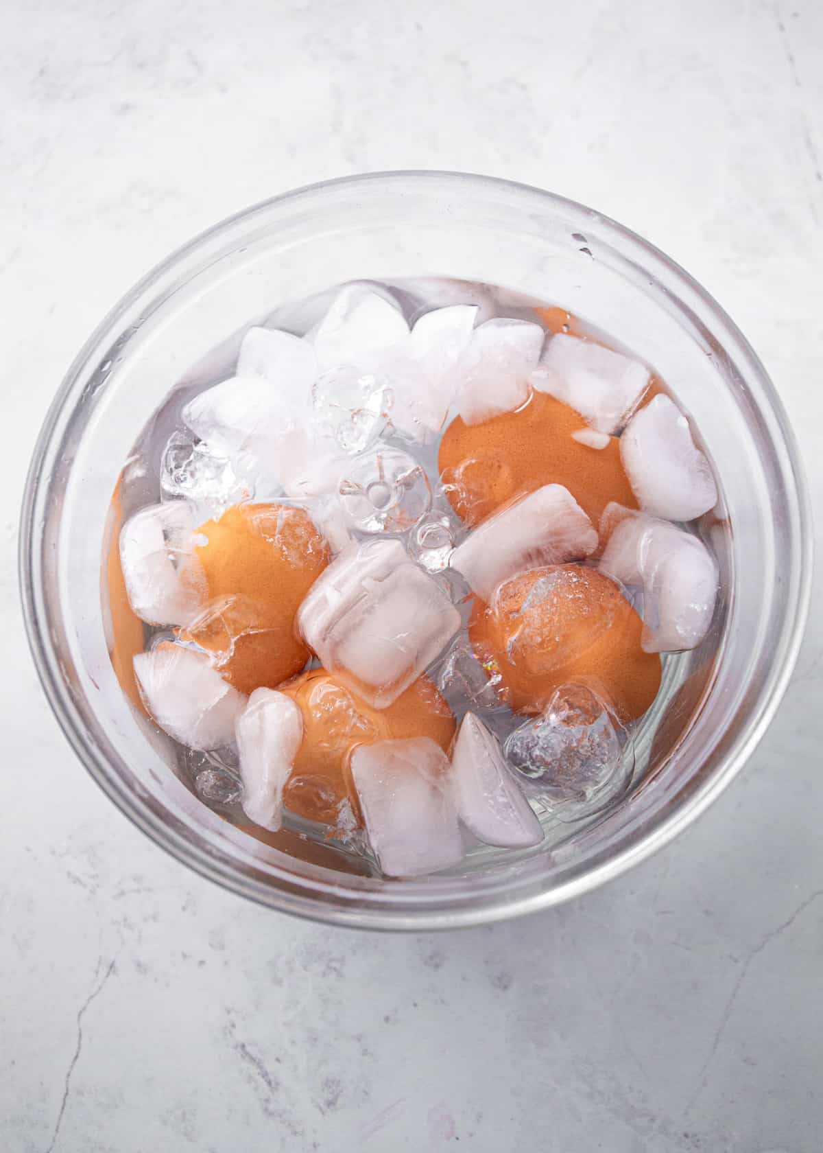 boiled eggs in ice water in a glass bowl