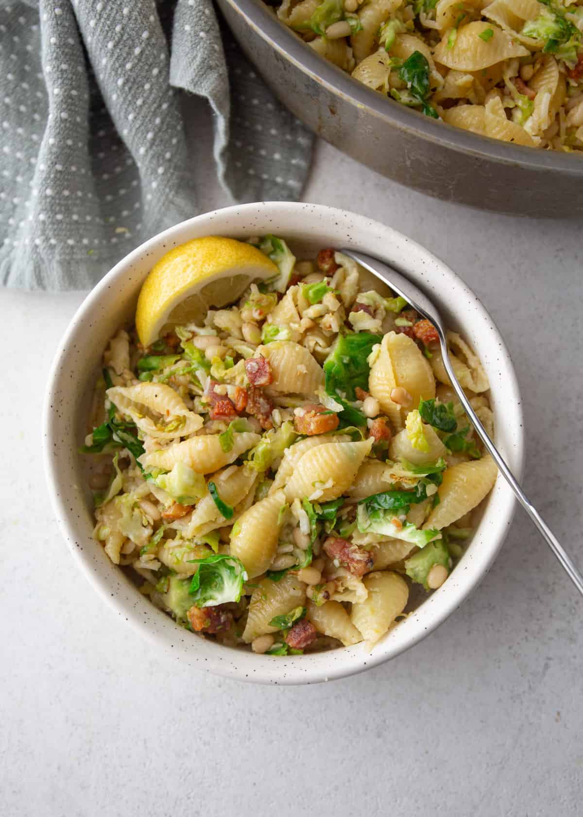 pasta with brussels sprouts in a white bowl