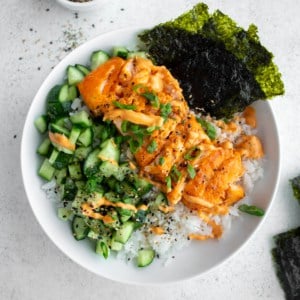 salmon, vegetables and rice in a white bowl