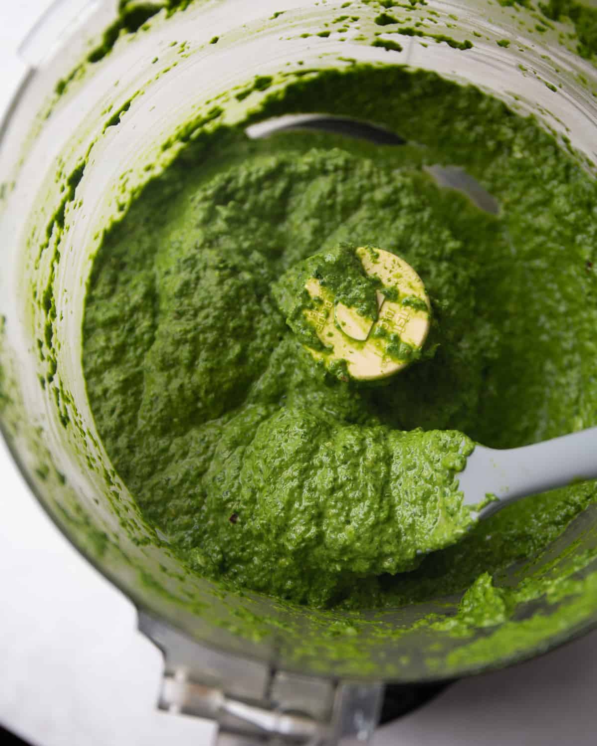 spinach pesto in the bowl of a food processor