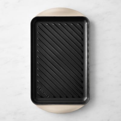a black grill pan on a grey background