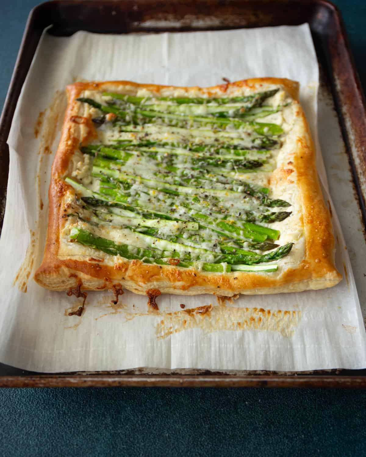 asparagus puff pastry on a parchment lined sheet pan