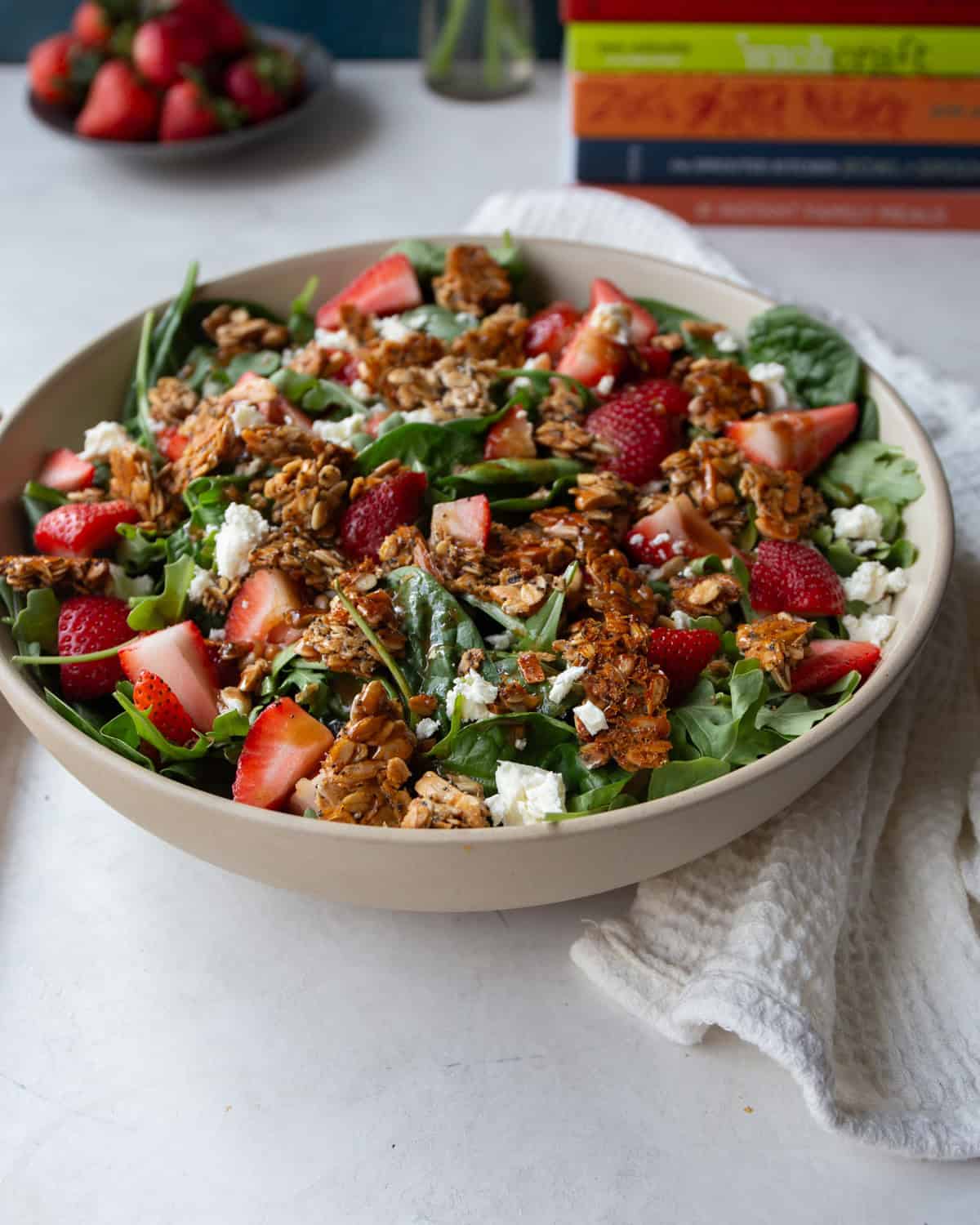 strawberry feta salad in a white bowl on a grey countertop