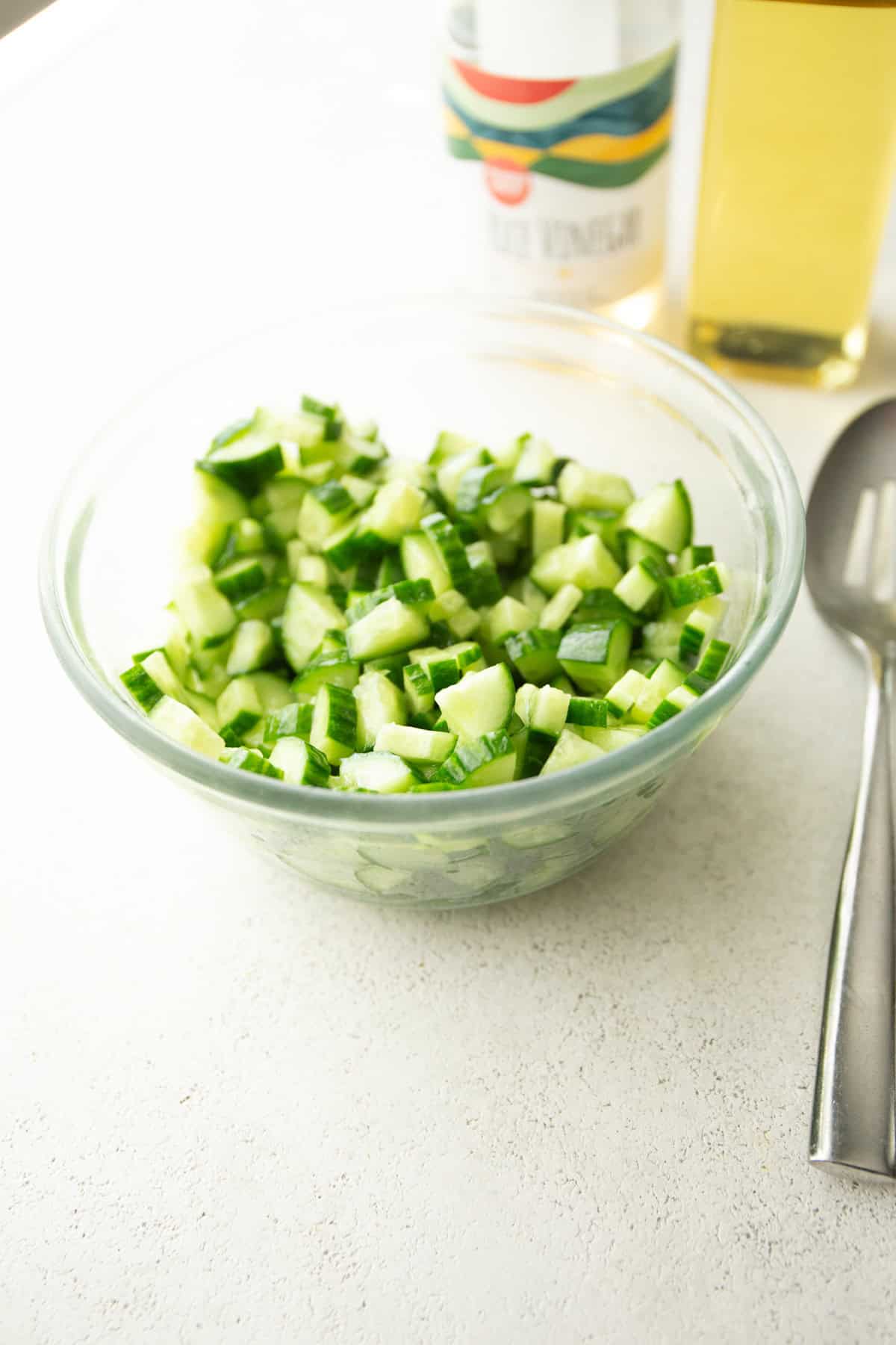 chopped cucumbers in a glass bowl