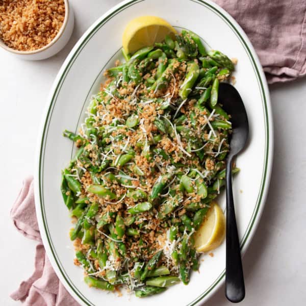 overhead image of asparagus salad on a white oval platter