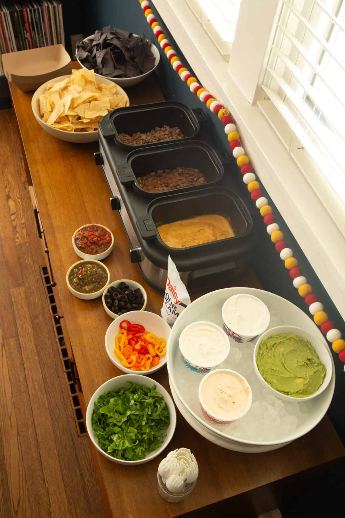 overhead image of nacho bar on a wooden cabinet