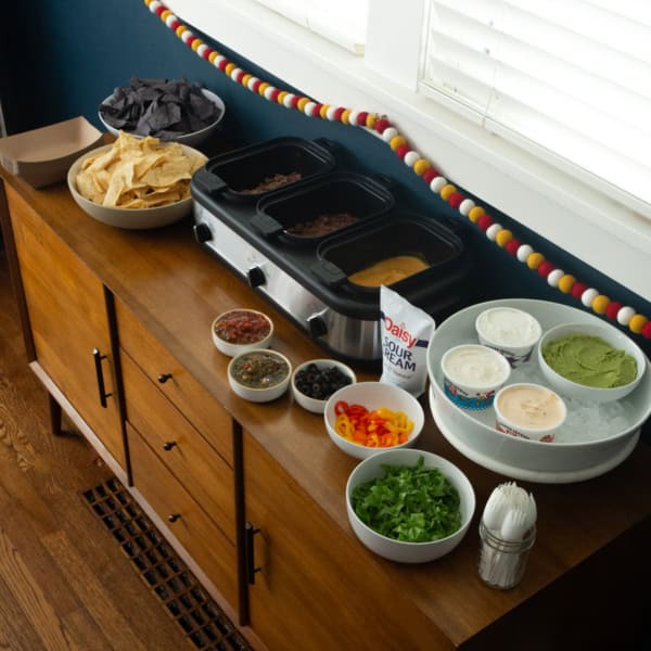 a nacho bar on a wood cabinet