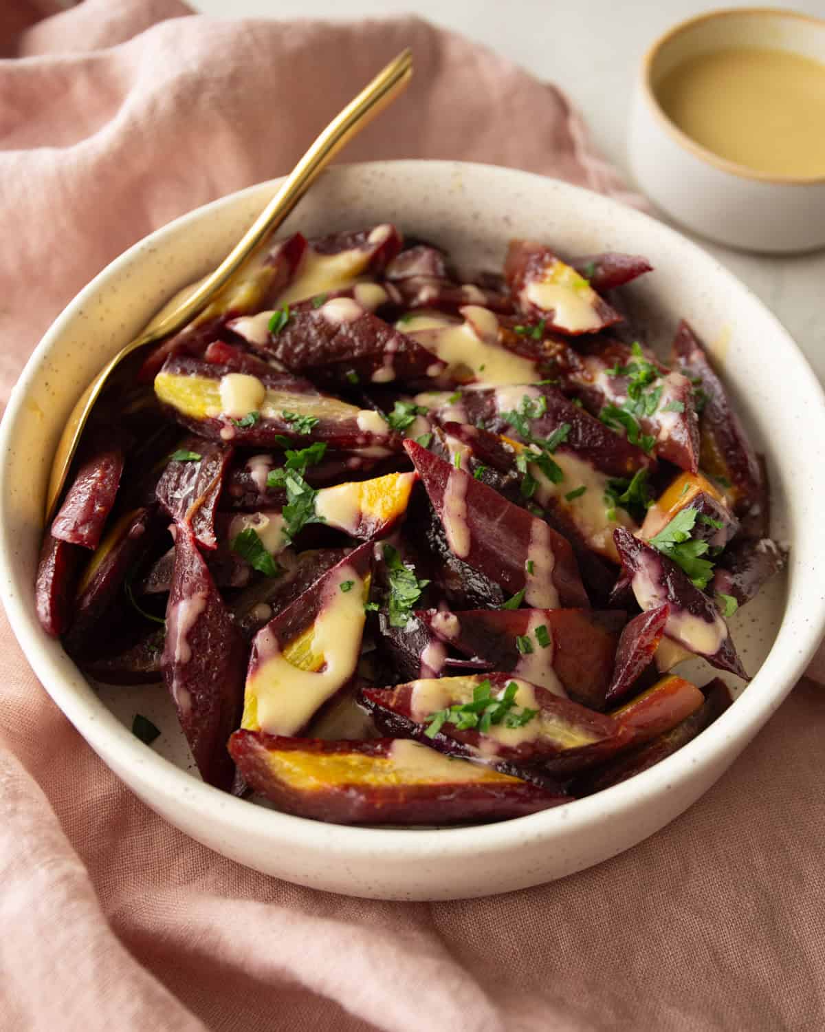 roasted purple carrots in a white bowl