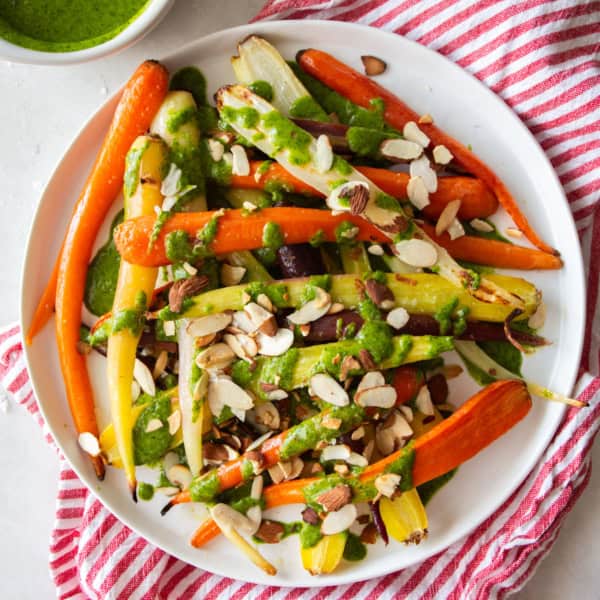 overhead image of roasted rainbow carrots on a white plate