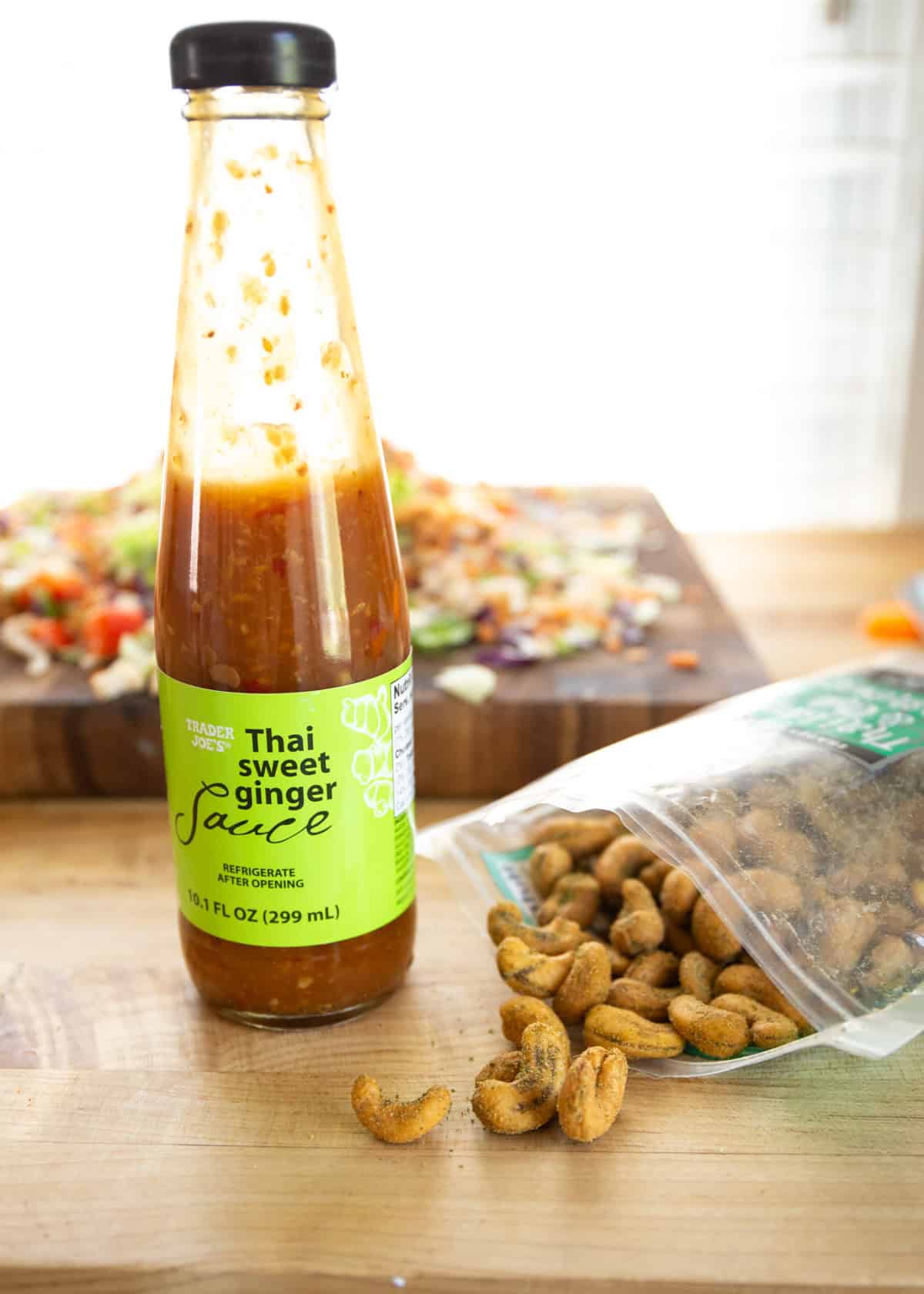 Thai ginger sauce and cashews on a wooden cutting board