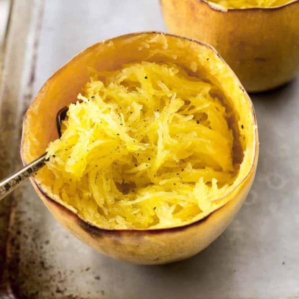 whole roasted spaghetti squash on a half sheet pan