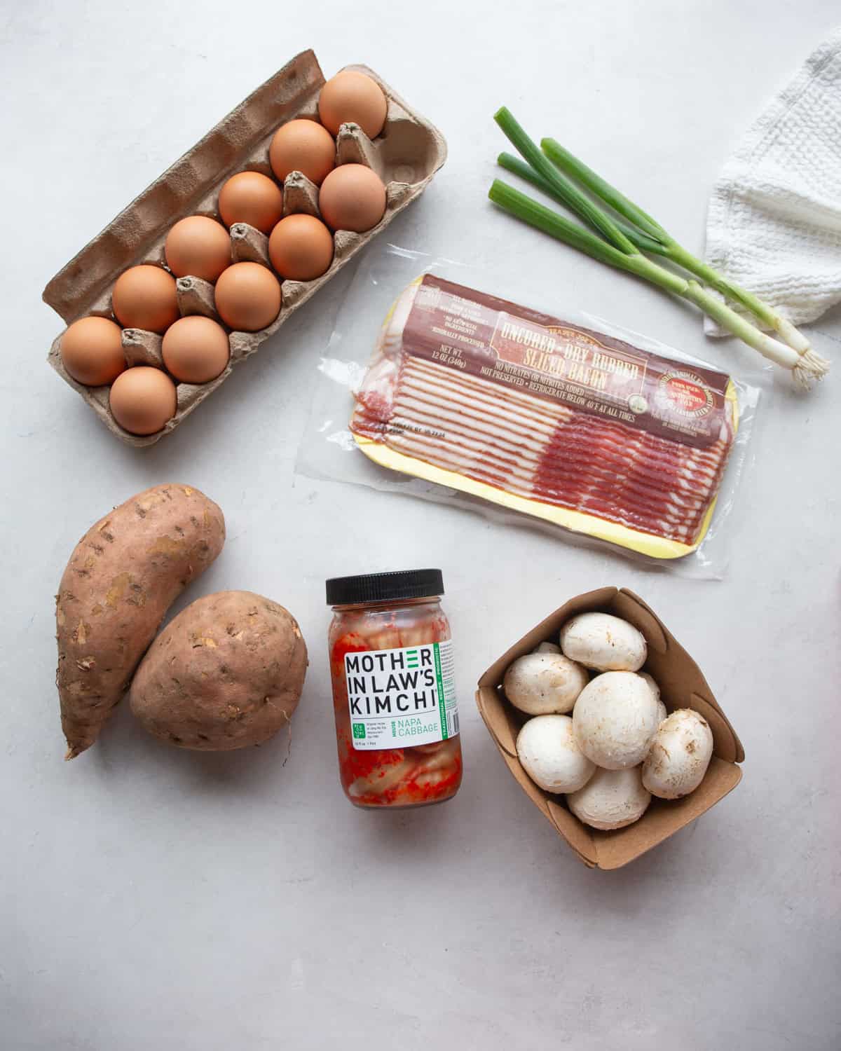 overhead image of ingredients for sweet potato hash on a white countertop