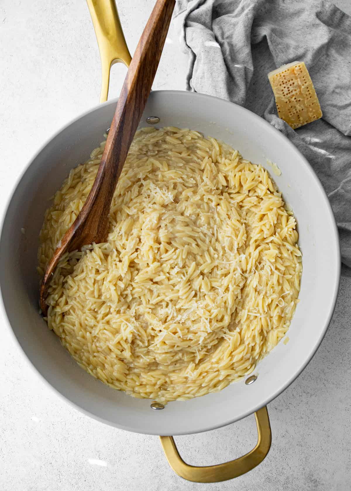 overhead image of parmesan orzo in a large pan