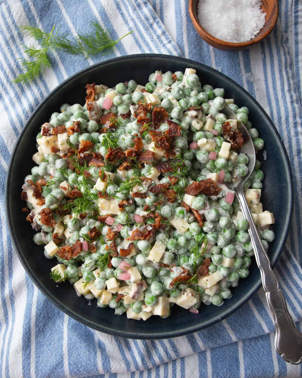 overhead image of pea salad in a black bowl