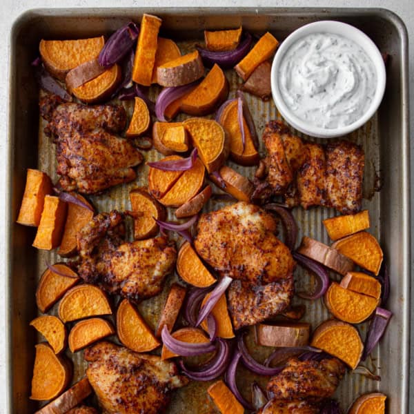 overhead image of chicken and sweet potatoes on a sheet pan