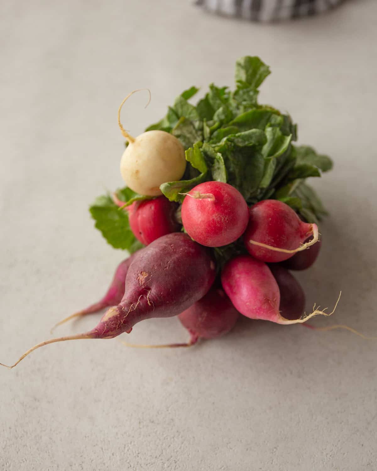 a bunch of radishes on a white countertop