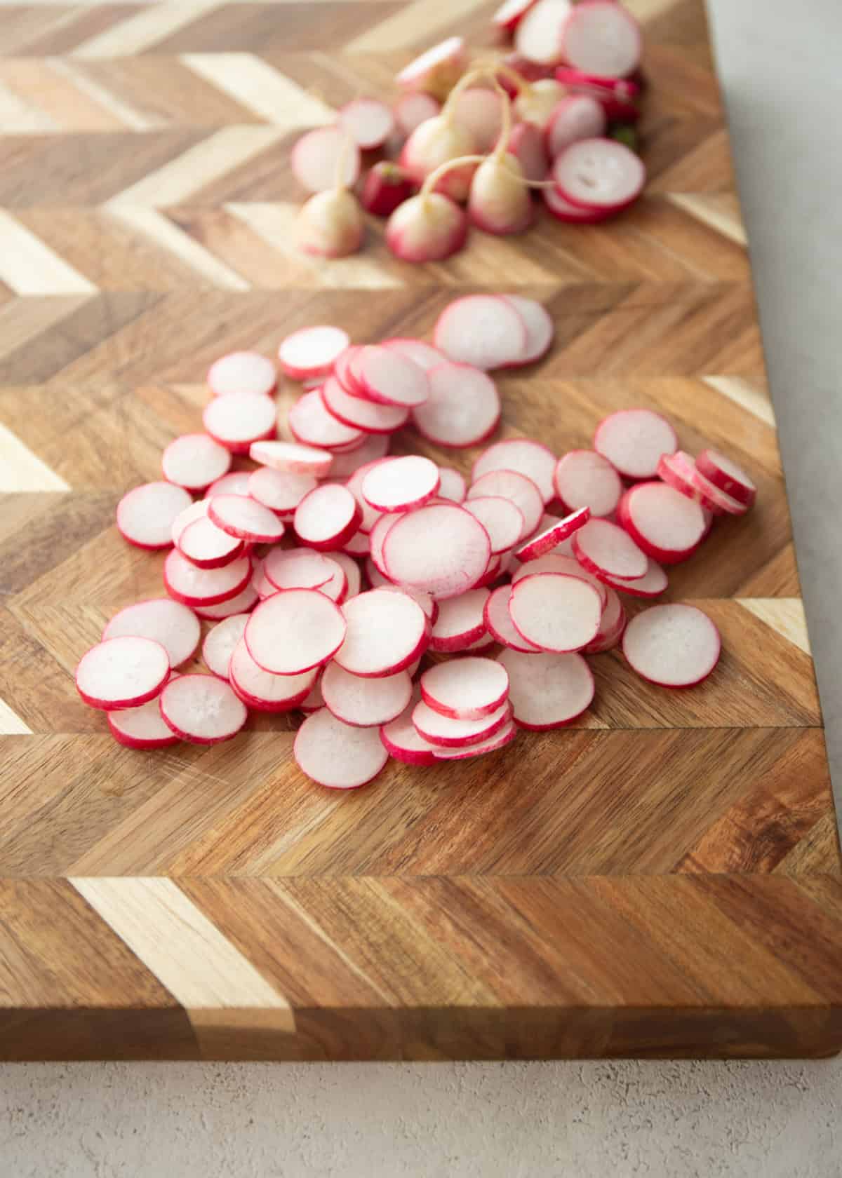 sliced radishes on a wood cutting board