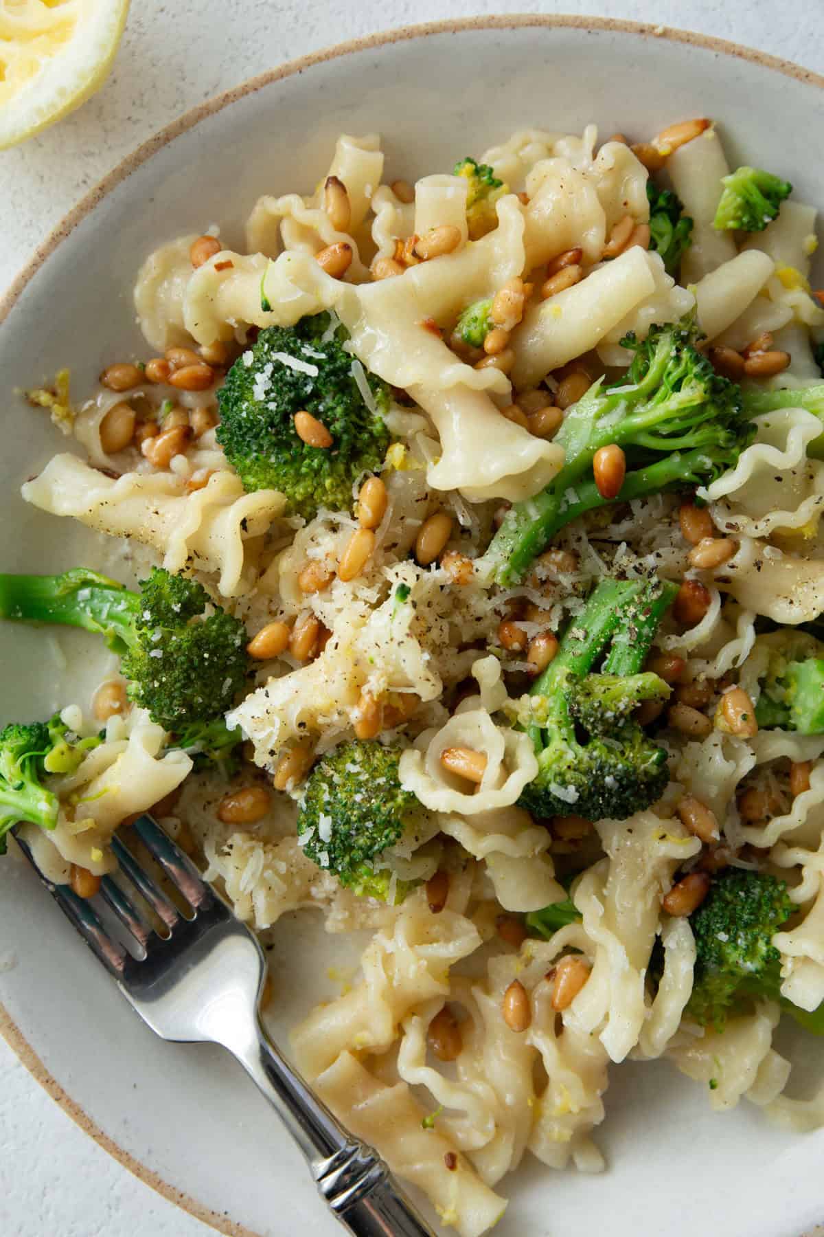 overhead image of broccoli pasta on a white plate