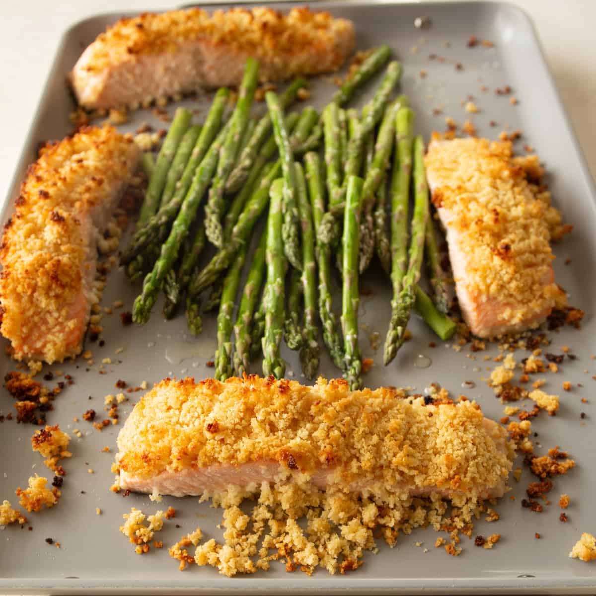 cooked salmon and asparagus on a sheet pan