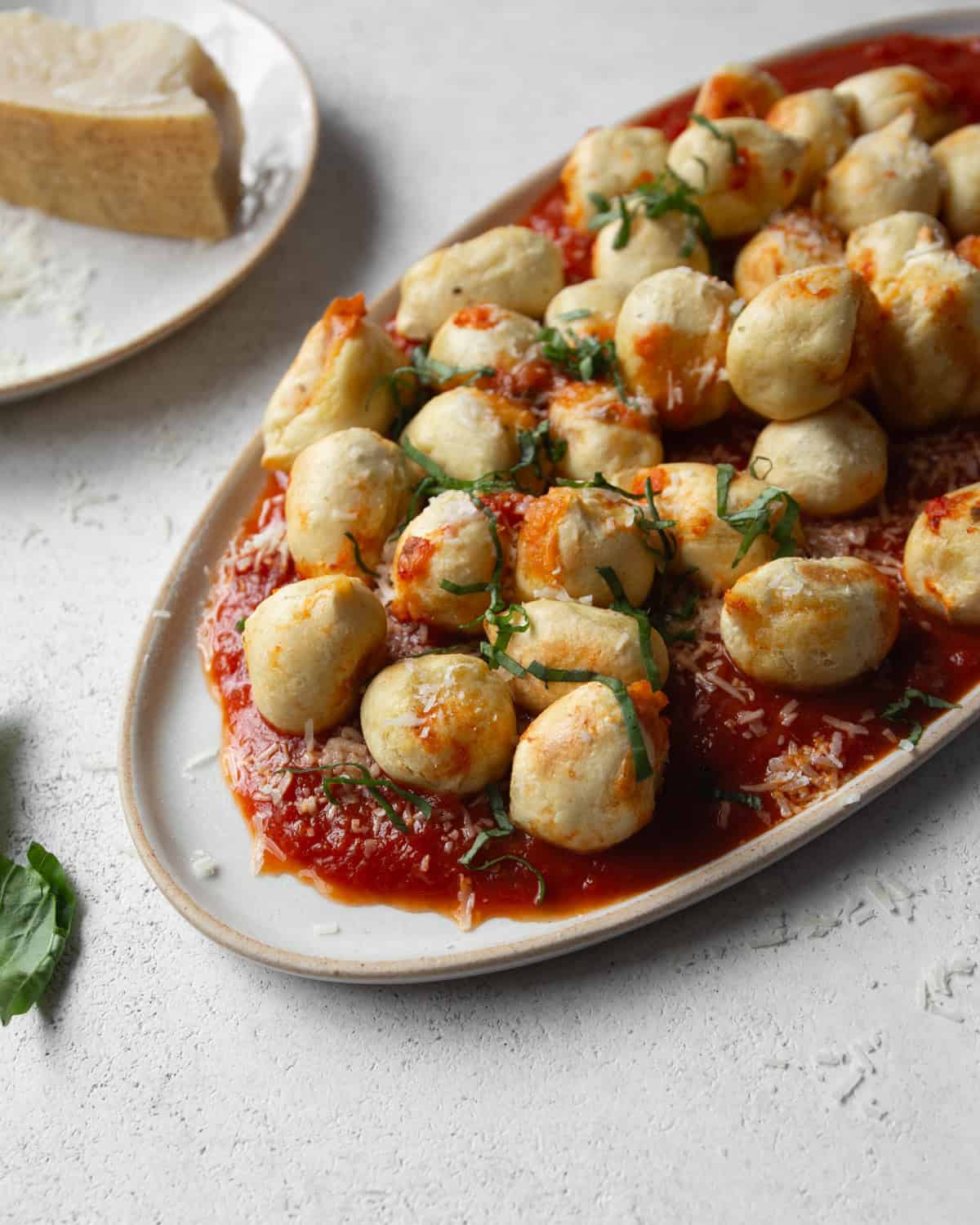 gnocchi and sauce on an oval plate