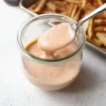 a spoon in a small jar of yum yum sauce