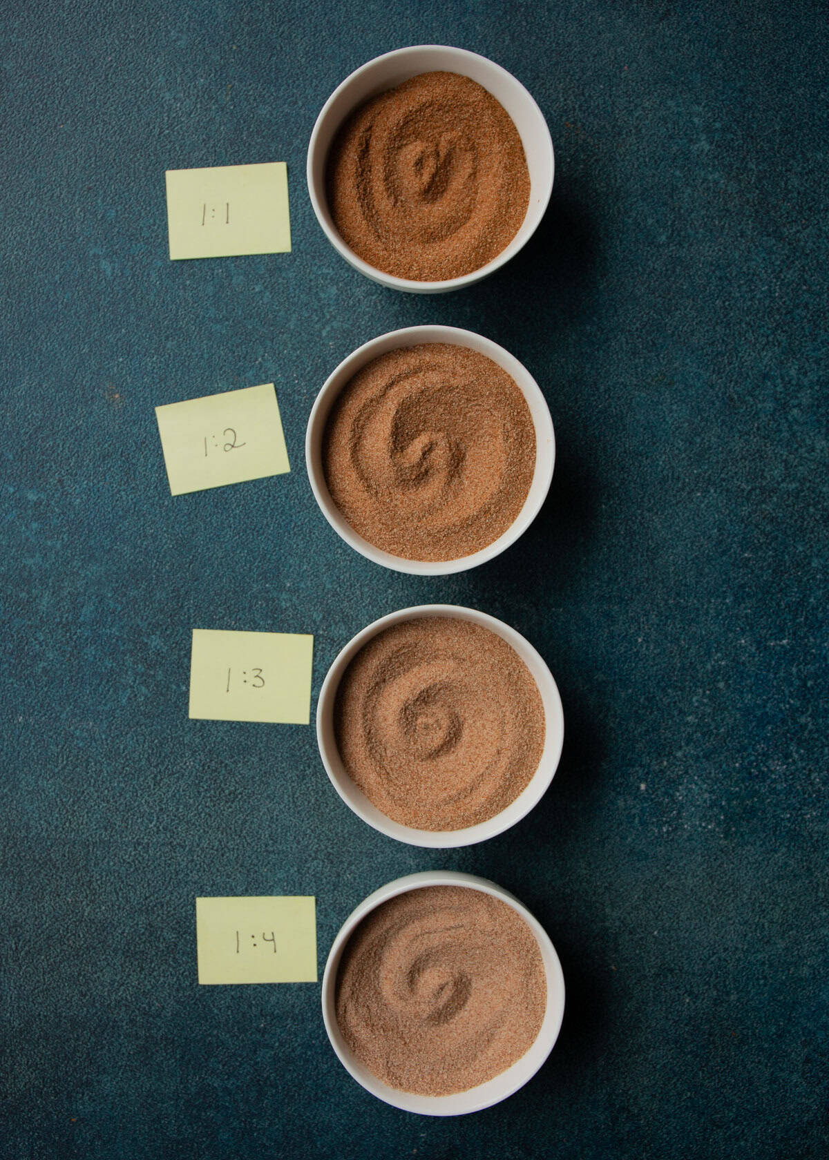 overhead image of different mixes of cinnamon sugar in white ramekins