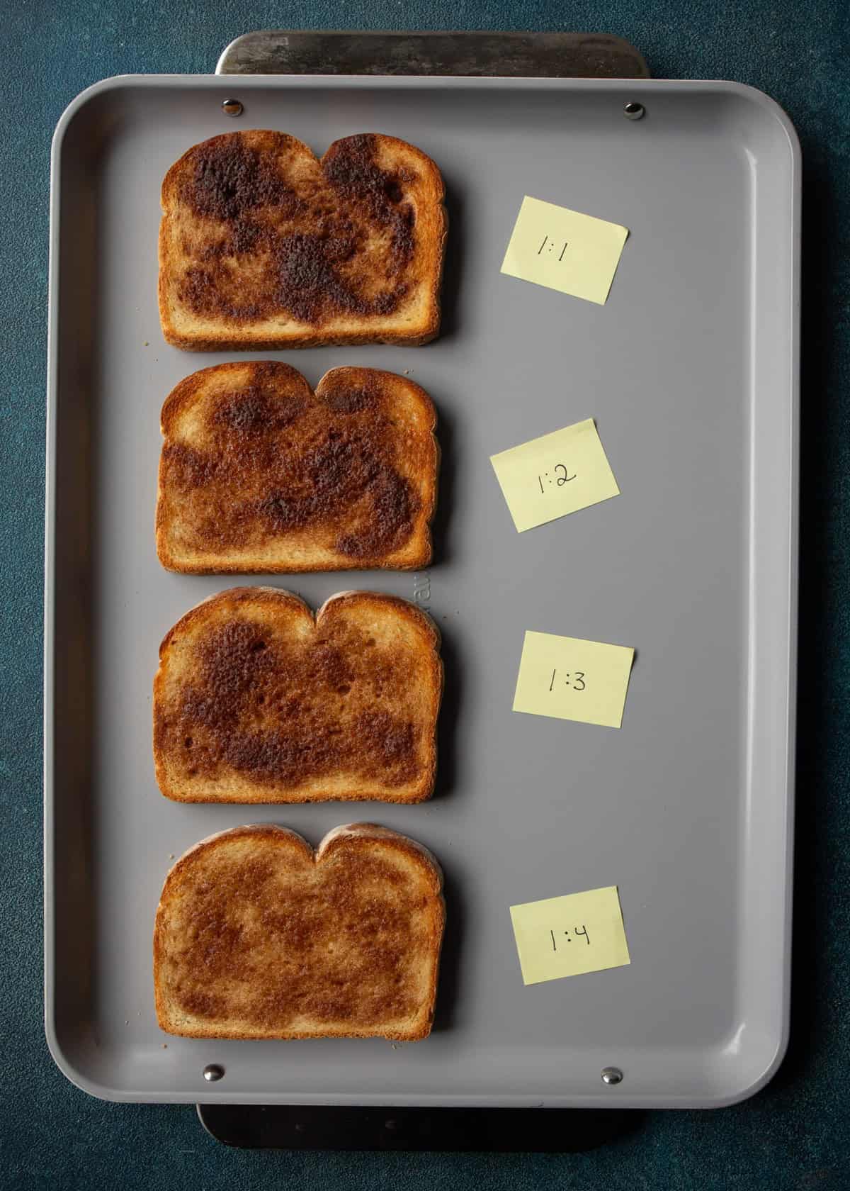 overhead image of different pieces of cinnamon toast on a baking sheet