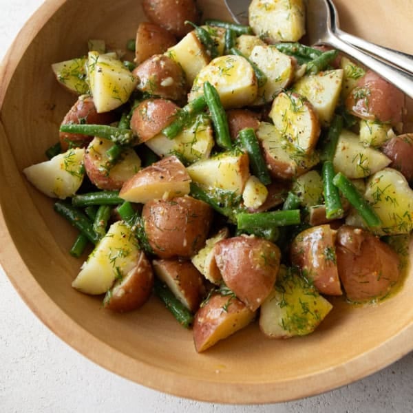 green bean and potato salad in a wooden salad bowl