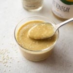 a spoon in a small ramekin of miso dressing