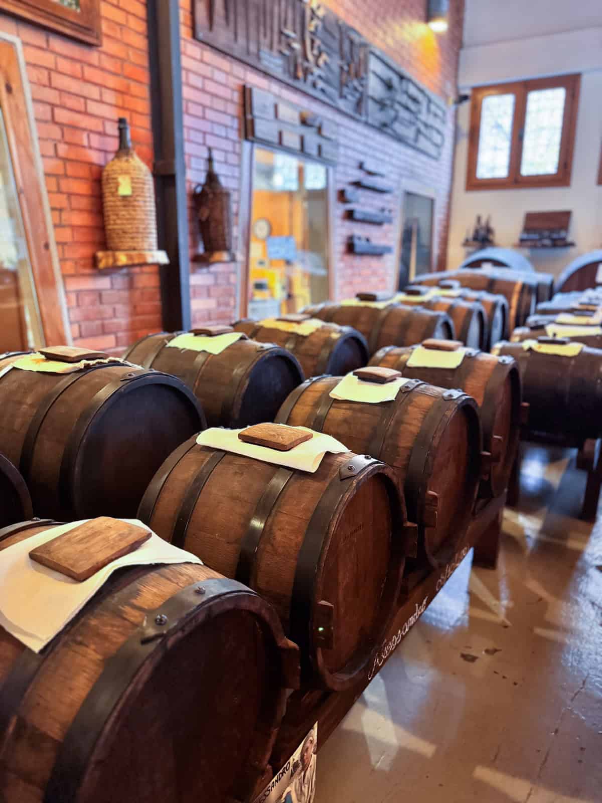 rows of wooden barrels in Antica Acetaia, Cavedoni in Modena Italy where they produce and age authentic balsamic vinegar