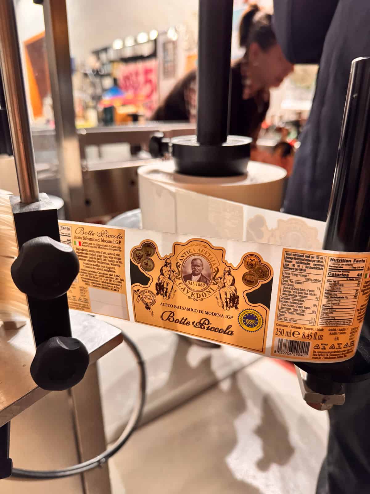 a close-up of a small sticker label of the labe-maker for Antica Acetaia, Cavedoni in Modena Italy where they produce and age authentic balsamic vinegar