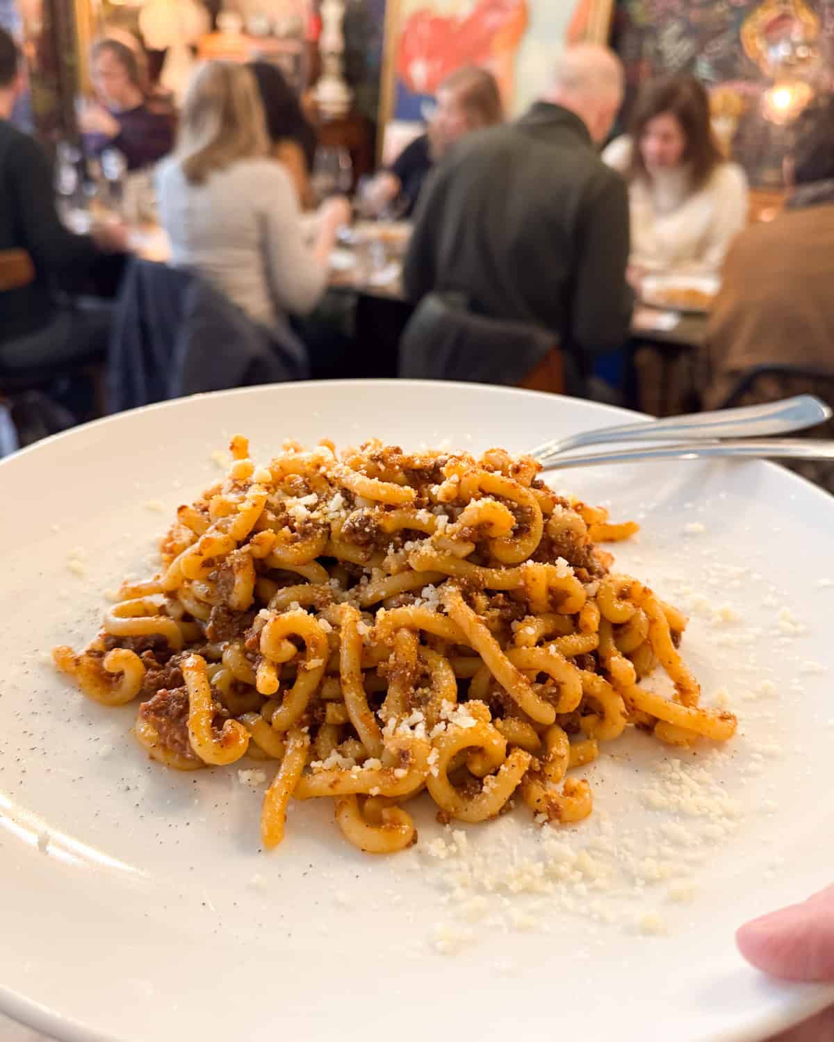 a plate of pasta with meat red sauce